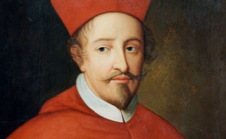 Cardinal Beaton wearing a red robe and hat, looking out to the viewer.